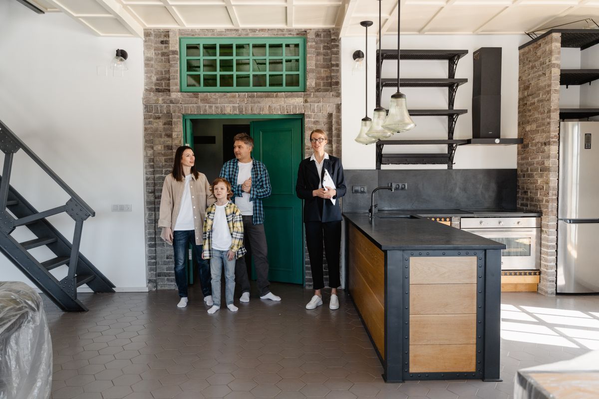 A remodeled kitchen with new cabinets, stainless appliances, and an island, the kind of capital improvement that raises a home's basis and lowers the taxable gain